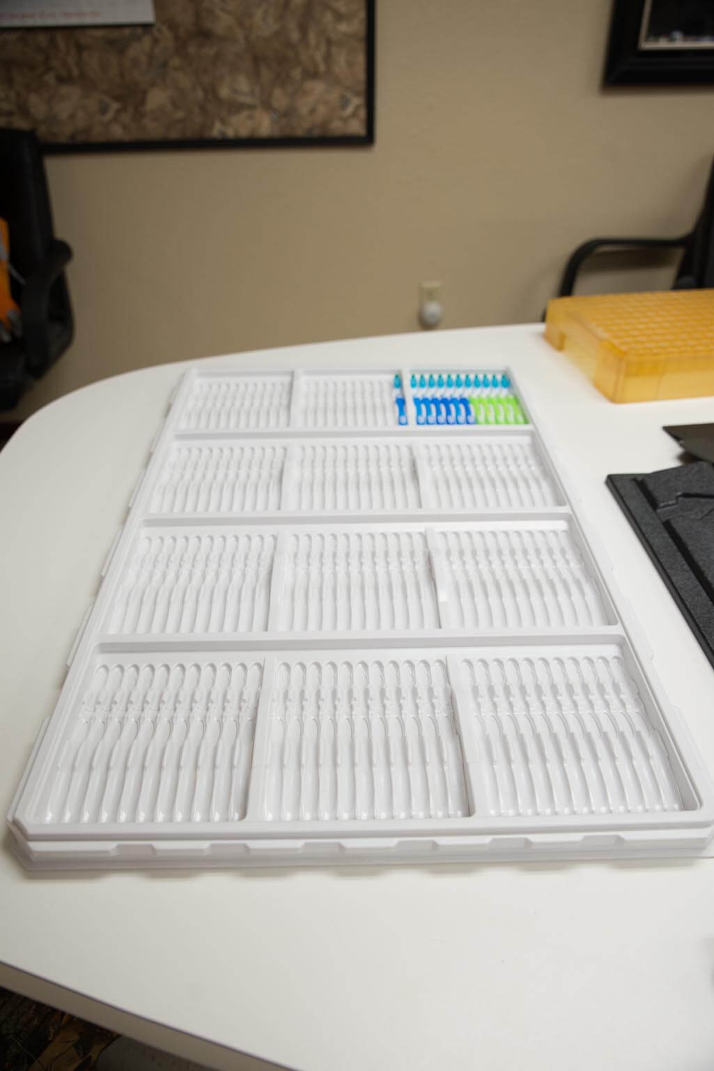 Pressure formed work in process tray used to transport toothbrushes.