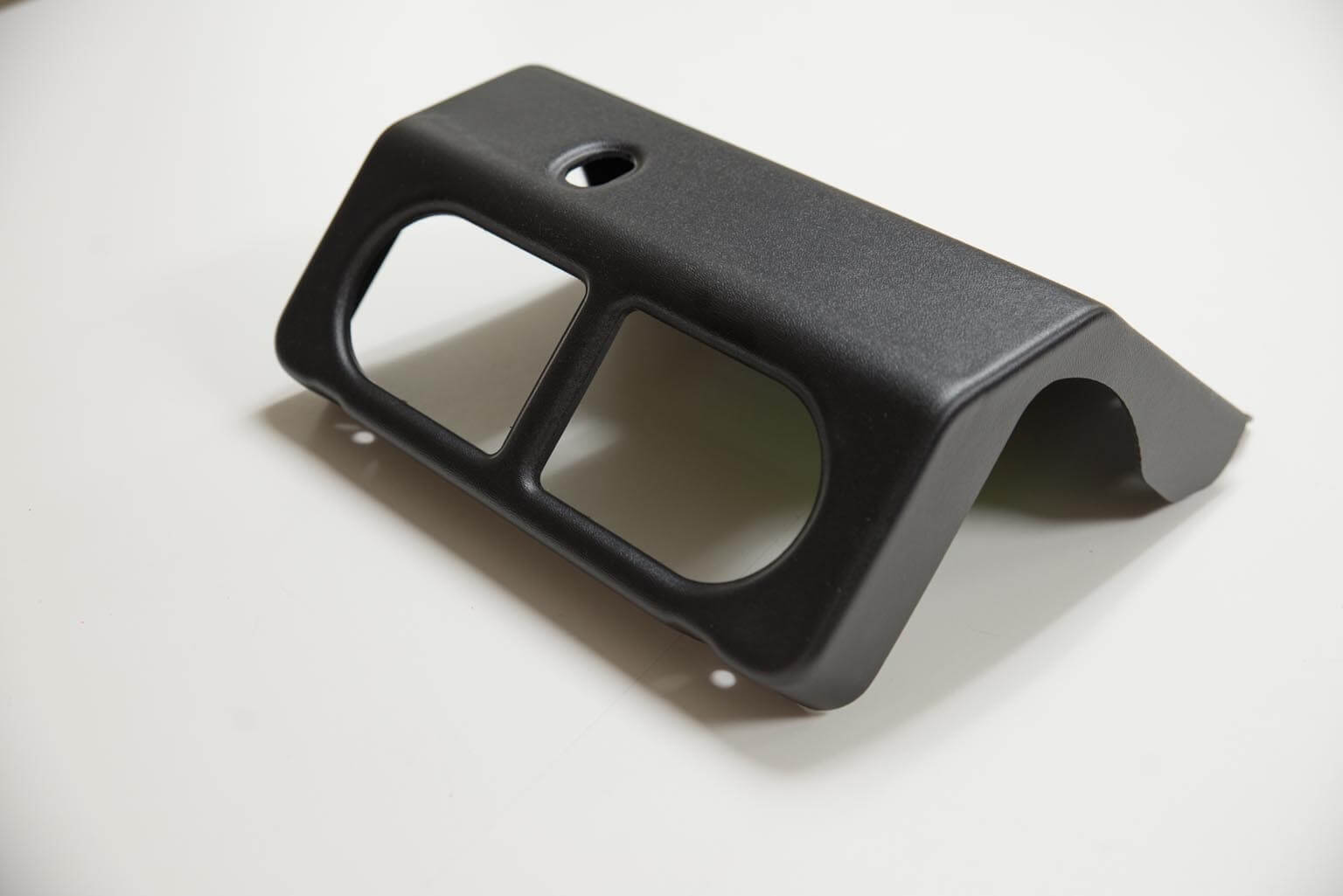 Color matched black textured ABS plastic part.