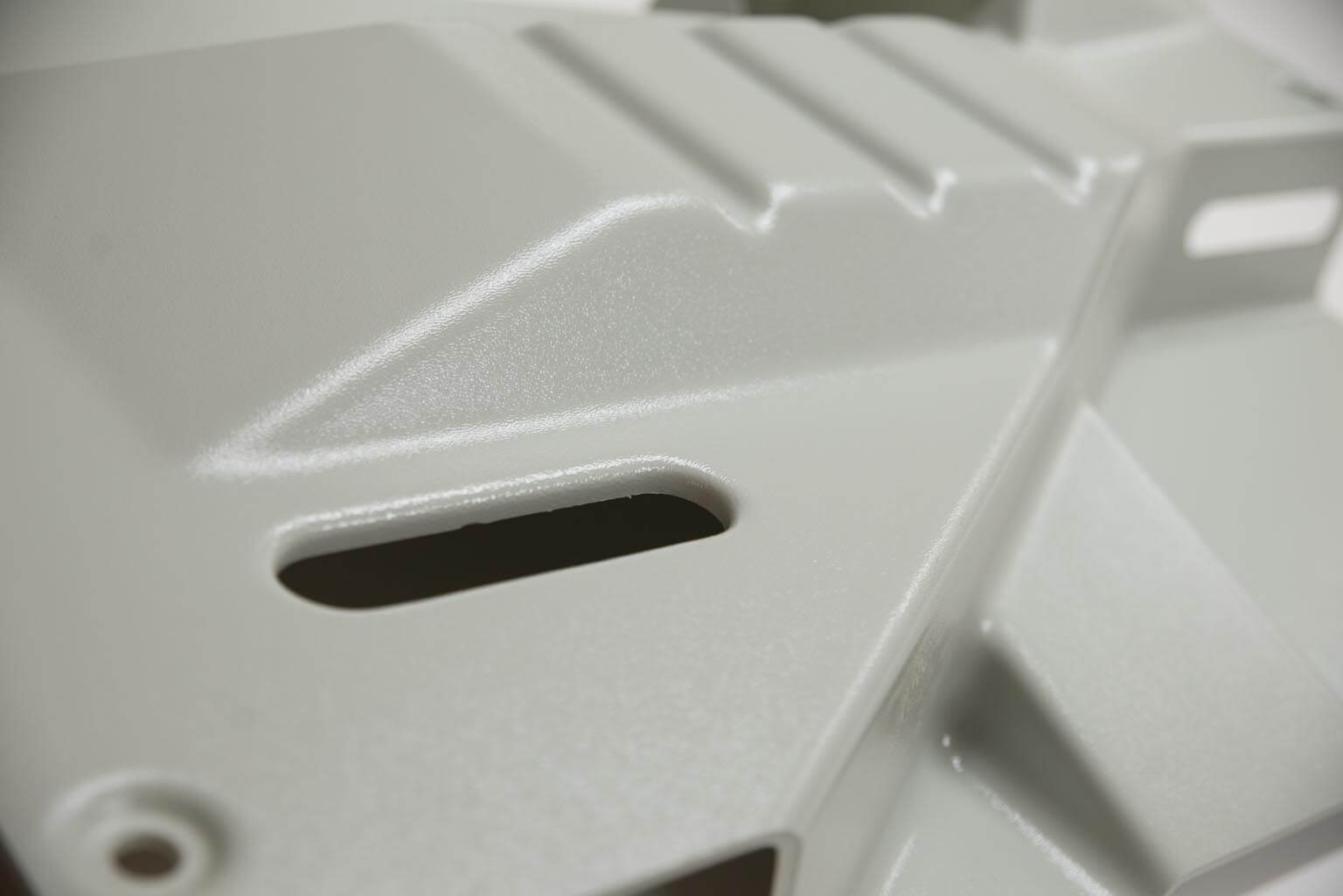 Color matched textured ABS plastic part.
